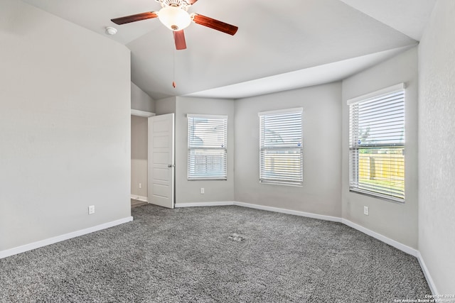 empty room with carpet, a healthy amount of sunlight, ceiling fan, and lofted ceiling