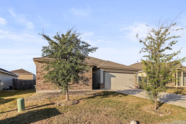 view of front of house with central AC unit, a garage, and a front lawn