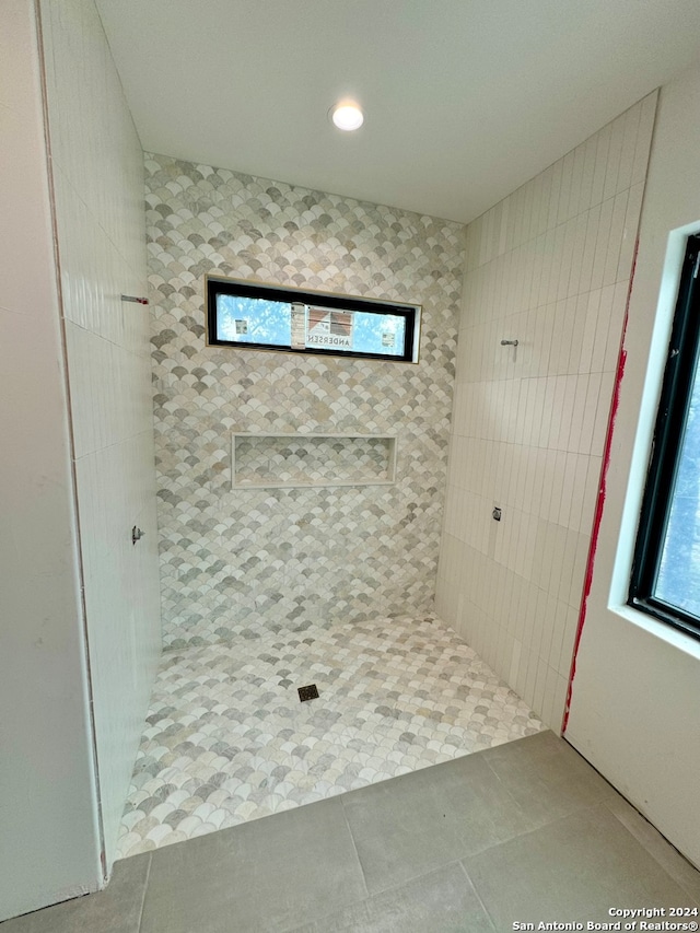 bathroom with walk in shower and tile patterned floors