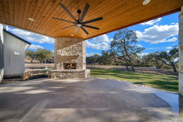 view of patio / terrace with ceiling fan and an outdoor stone fireplace