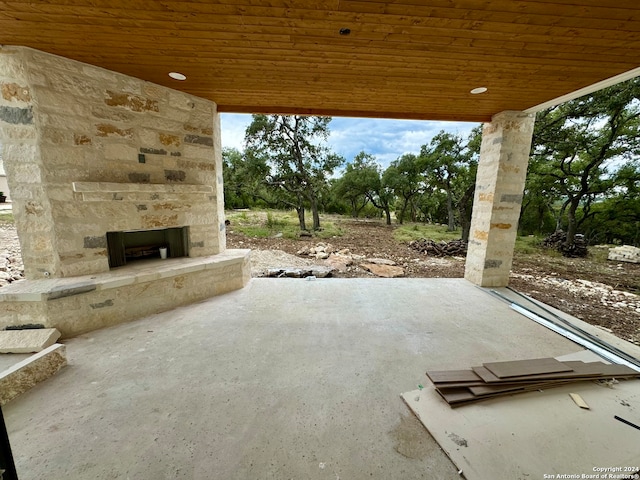 view of patio with an outdoor stone fireplace