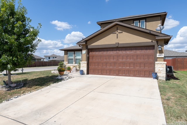 view of front of property with a front yard and a garage