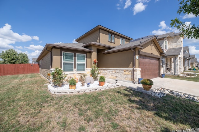 view of front facade featuring a front yard and a garage