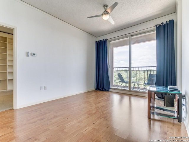 1 Towers Park Ln Unit 503, San Antonio, TX 78209 - unfurnished room with a textured ceiling, light wood-style flooring, and ceiling fan