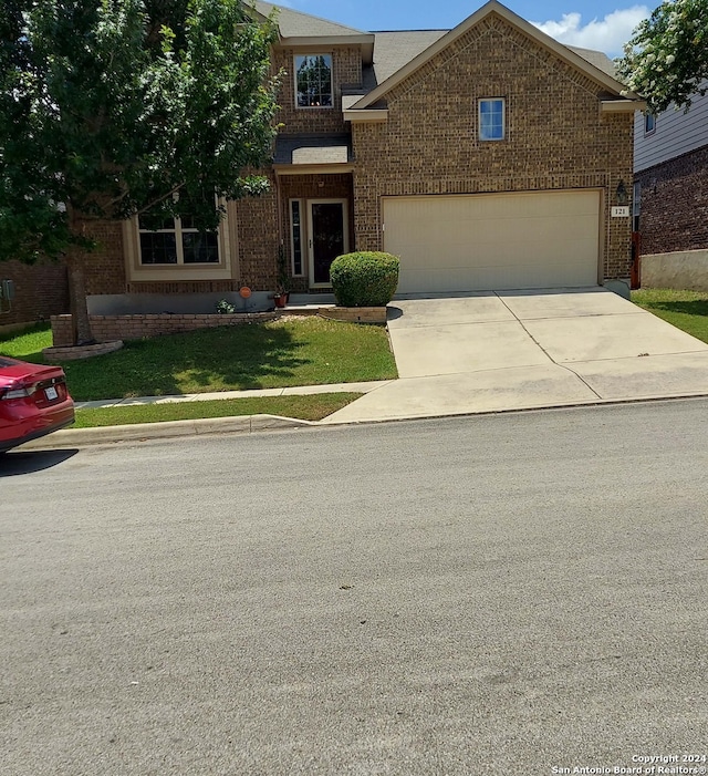 view of front of property with a front yard and a garage