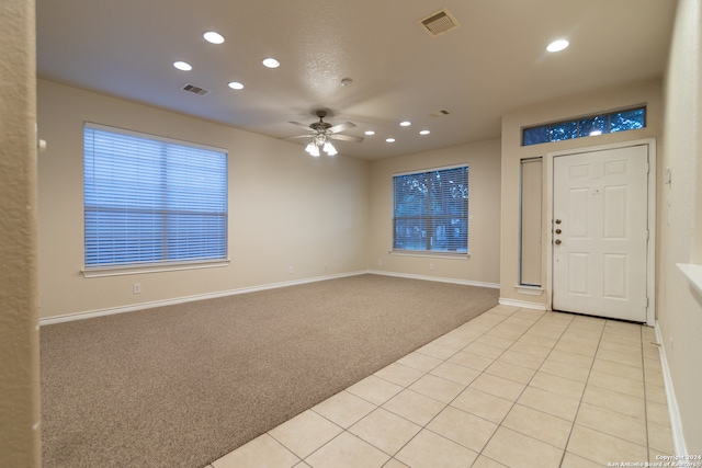 entrance foyer featuring ceiling fan and light colored carpet