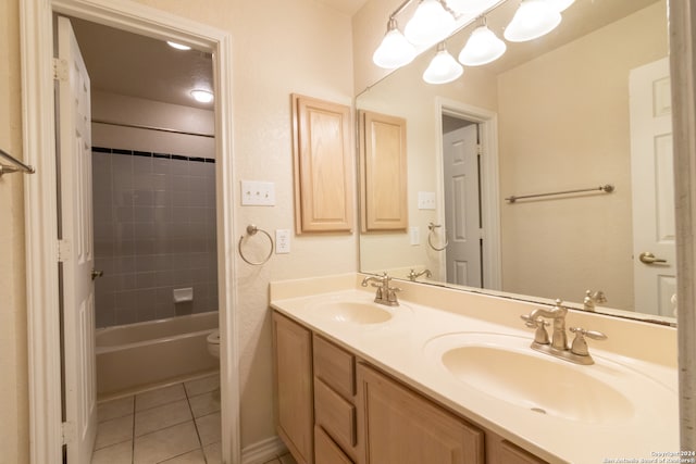 full bathroom with tile patterned flooring, vanity, toilet, and tiled shower / bath