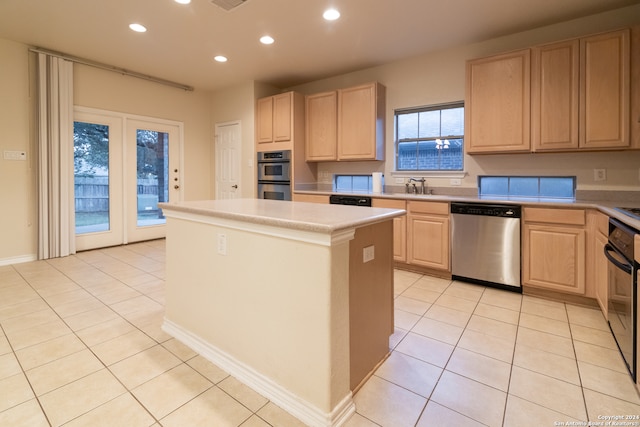 kitchen featuring appliances with stainless steel finishes, a kitchen island, light brown cabinets, and light tile patterned floors