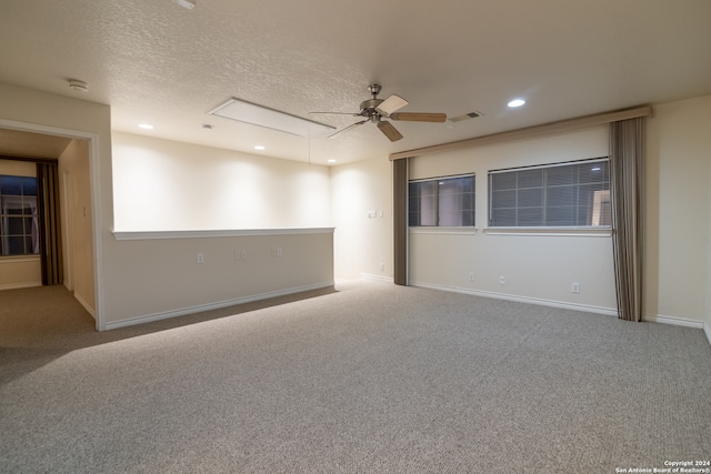 unfurnished room featuring carpet, ceiling fan, and a textured ceiling