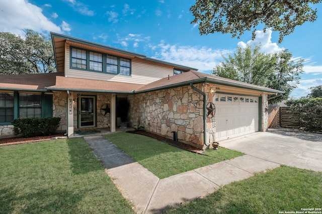 view of front of home with a front lawn and a garage