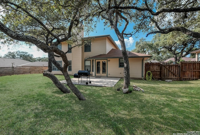 back of property featuring a lawn and a patio area