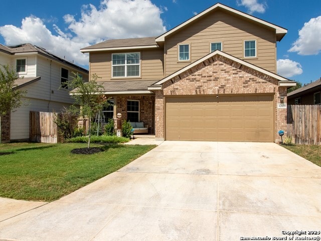 view of front of property with a front yard and a garage