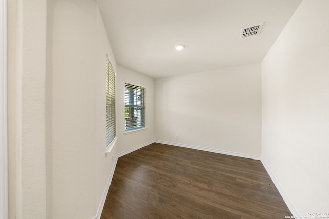 empty room featuring dark hardwood / wood-style flooring