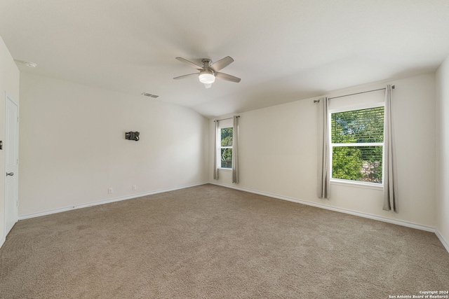 unfurnished room with light carpet, lofted ceiling, and ceiling fan