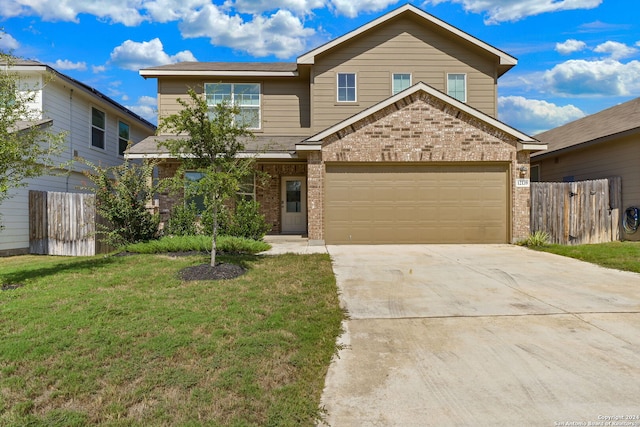 view of front of property featuring a front yard and a garage