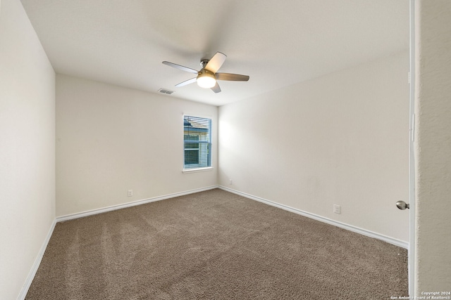 empty room with ceiling fan and carpet floors