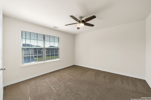 carpeted spare room featuring ceiling fan