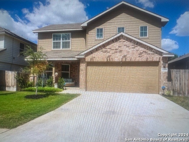 view of front of home featuring a garage and a front lawn