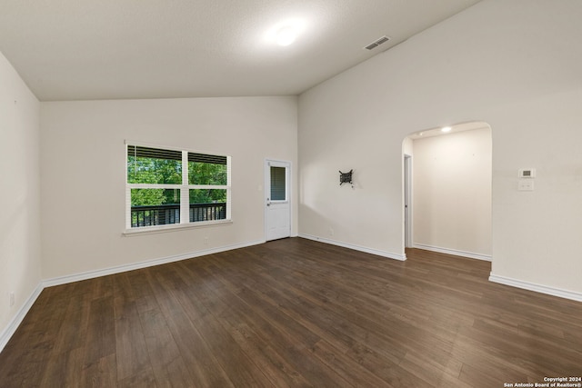 empty room featuring dark hardwood / wood-style floors and high vaulted ceiling