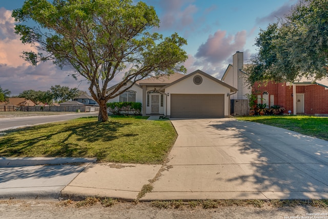 view of front of home with a front lawn and a garage