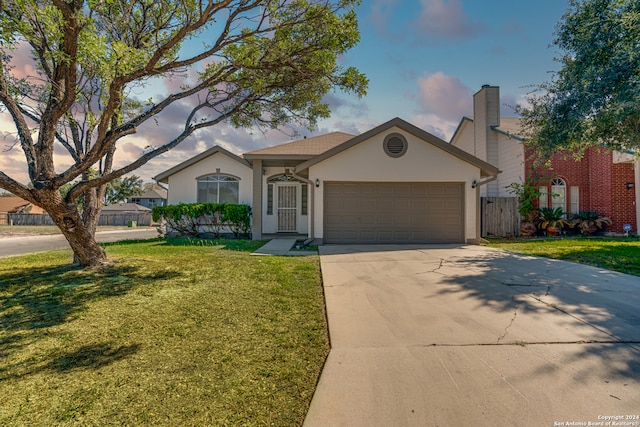 view of front of house with a garage and a front lawn