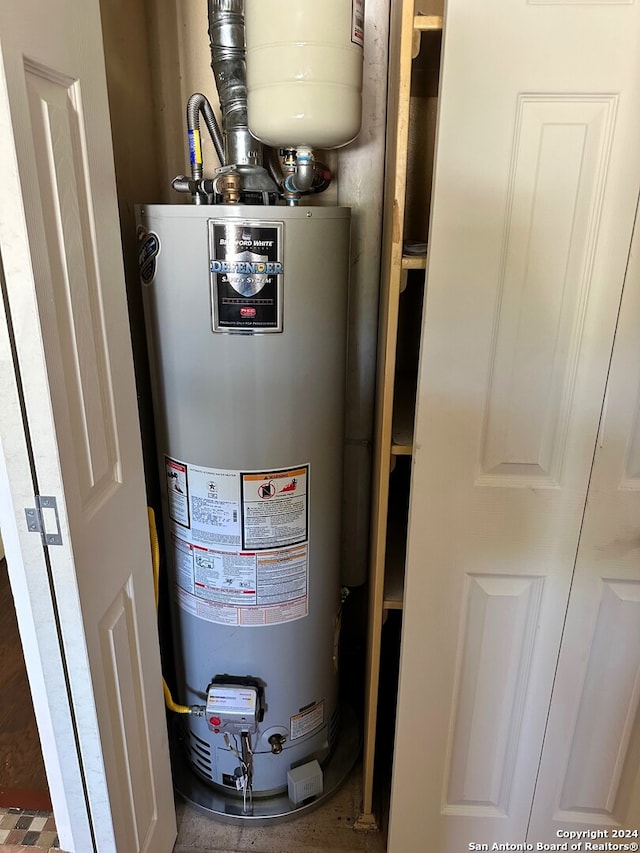 utility room featuring water heater