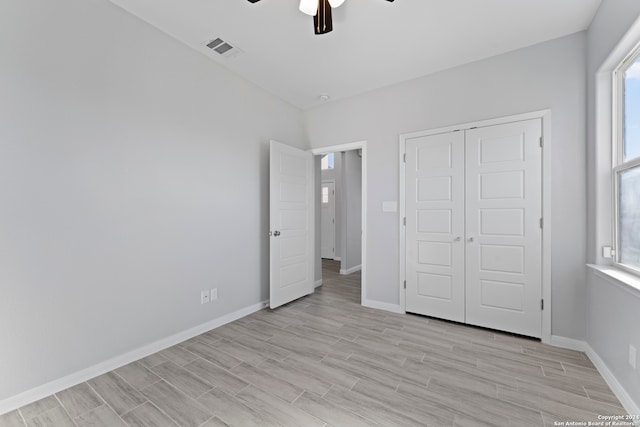 unfurnished bedroom featuring ceiling fan, a closet, and light hardwood / wood-style floors