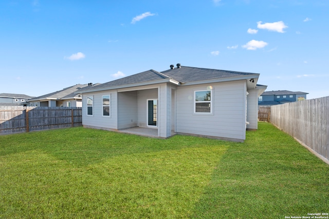 back of house with a yard and a patio area