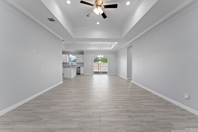 unfurnished living room with ceiling fan, a raised ceiling, crown molding, and light hardwood / wood-style flooring