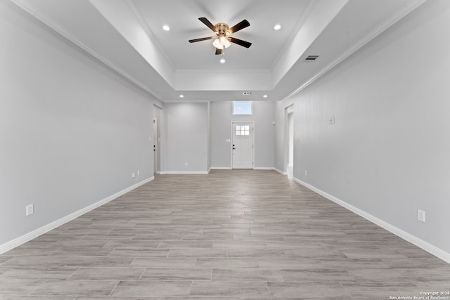 unfurnished living room featuring light hardwood / wood-style floors, ceiling fan, and crown molding