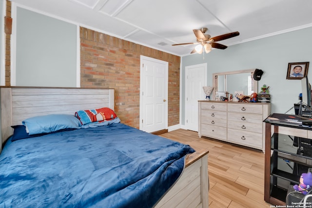 bedroom featuring light hardwood / wood-style flooring, ceiling fan, brick wall, and ornamental molding