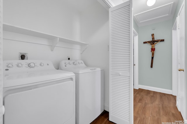 laundry area featuring independent washer and dryer and hardwood / wood-style flooring