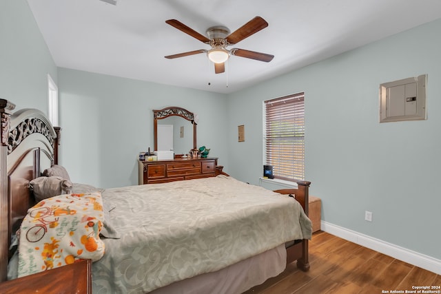 bedroom featuring electric panel, ceiling fan, and hardwood / wood-style flooring