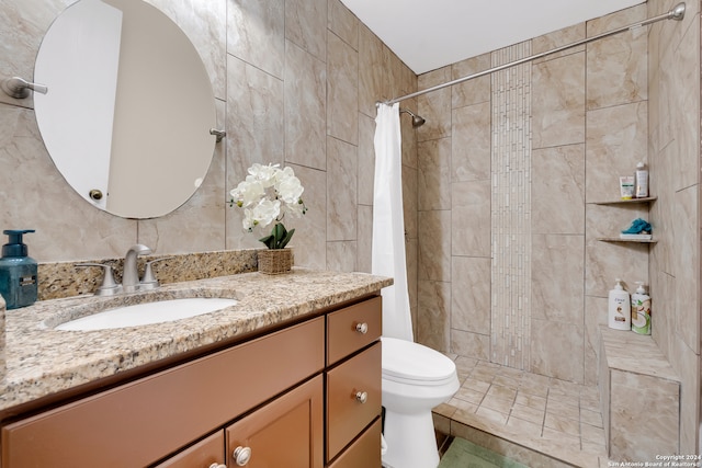 bathroom featuring tile walls, vanity, and curtained shower