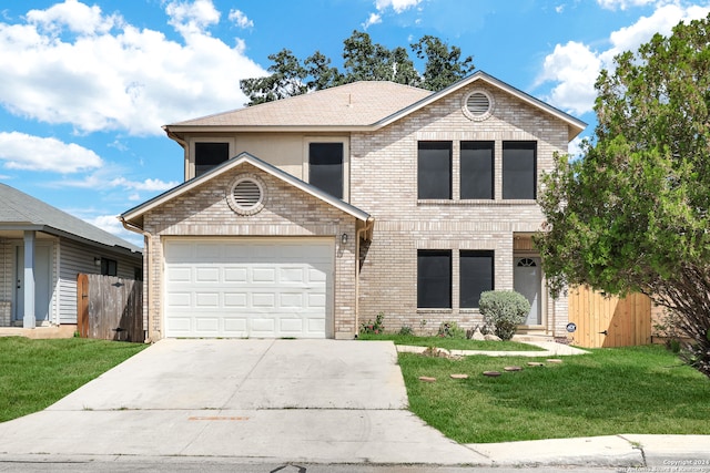 view of front property featuring a garage and a front lawn