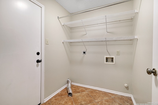 clothes washing area featuring hookup for a washing machine, hookup for a gas dryer, light tile patterned floors, and electric dryer hookup