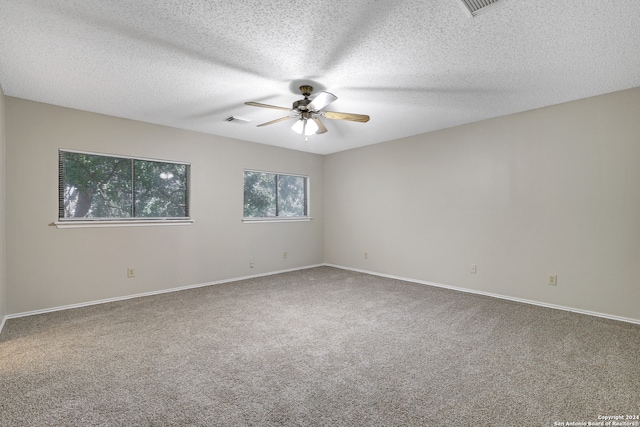 unfurnished room featuring a textured ceiling, carpet, and ceiling fan