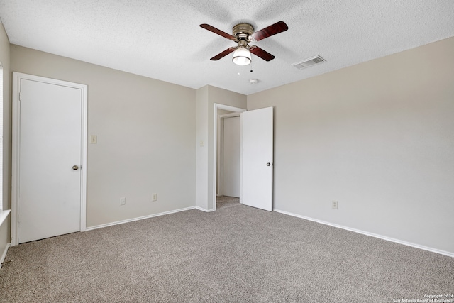 unfurnished bedroom with ceiling fan, a textured ceiling, and carpet flooring