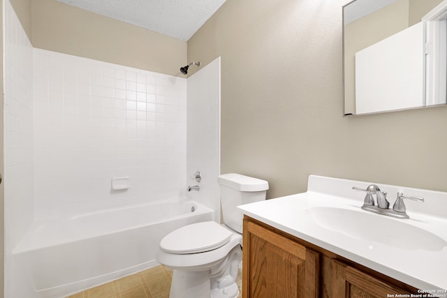 full bathroom featuring a textured ceiling, bathing tub / shower combination, vanity, and toilet