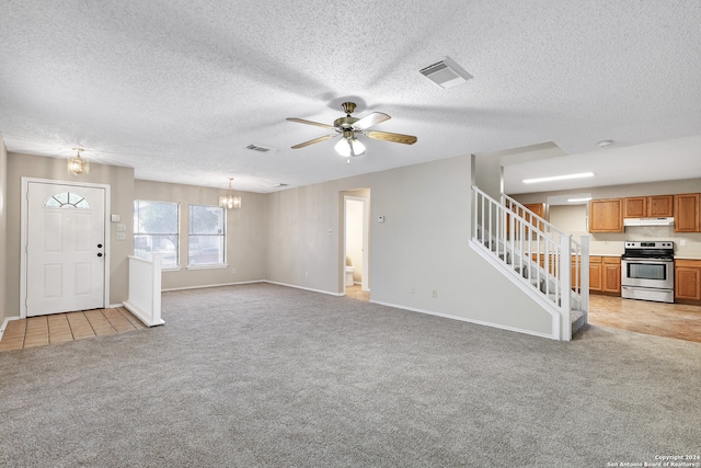 unfurnished living room featuring a textured ceiling, ceiling fan with notable chandelier, and light colored carpet