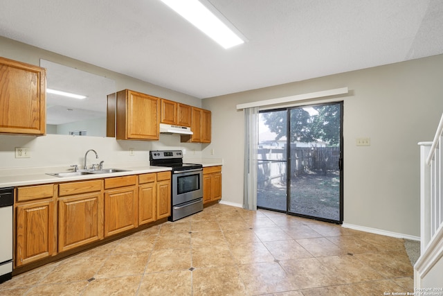 kitchen with light tile patterned flooring, sink, white dishwasher, and stainless steel electric range