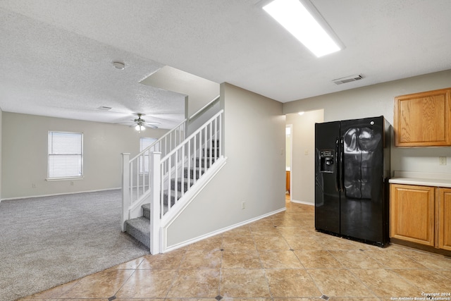 kitchen with light carpet, ceiling fan, a textured ceiling, and black refrigerator with ice dispenser