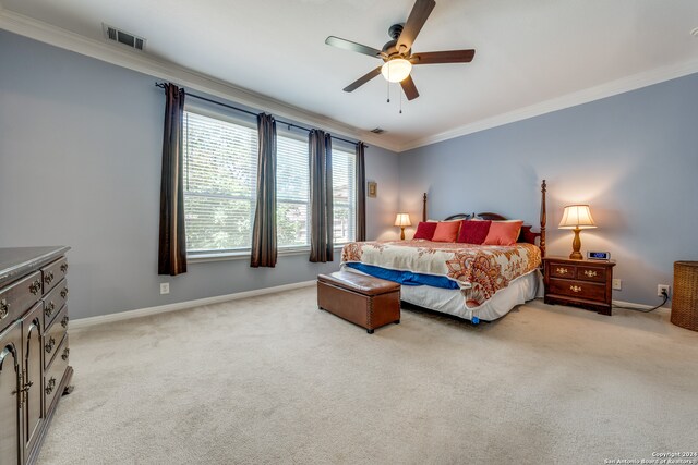 bedroom with ceiling fan, light carpet, and ornamental molding