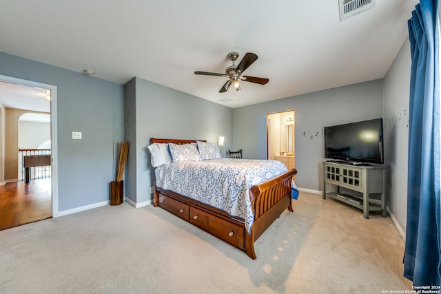 carpeted bedroom with ceiling fan and connected bathroom