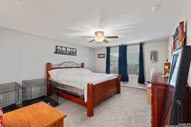 carpeted bedroom featuring a textured ceiling and ceiling fan