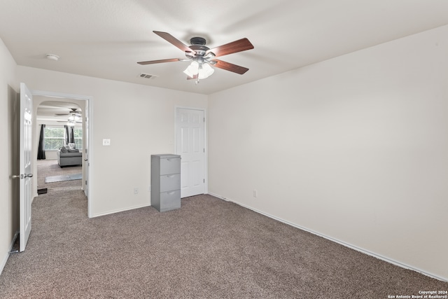 unfurnished bedroom featuring carpet and ceiling fan