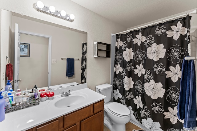 bathroom featuring curtained shower, vanity, a textured ceiling, tile patterned flooring, and toilet