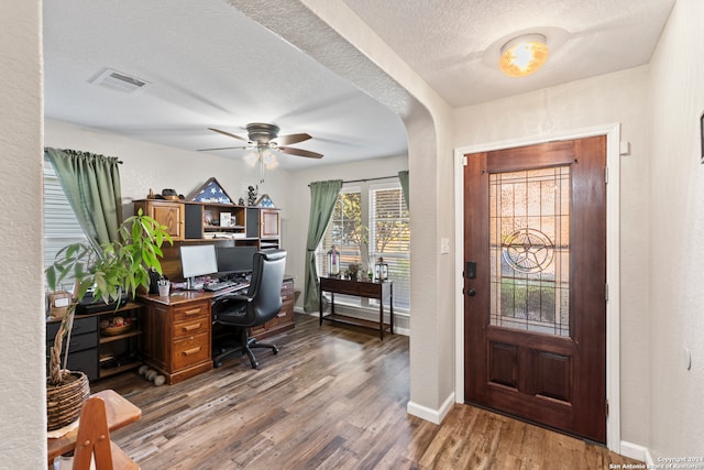 interior space featuring ceiling fan, a textured ceiling, and dark hardwood / wood-style flooring