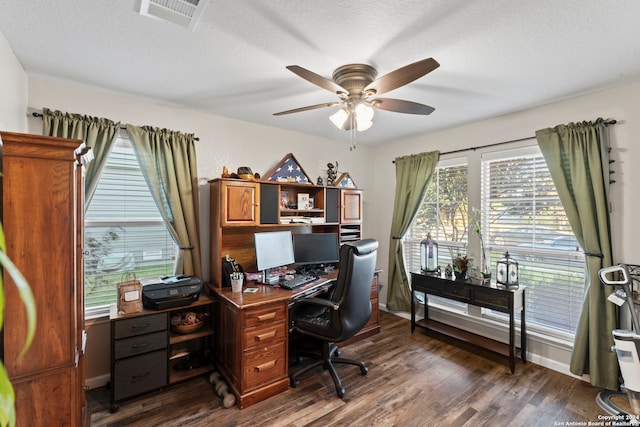 office area featuring ceiling fan, dark wood-type flooring, and a textured ceiling