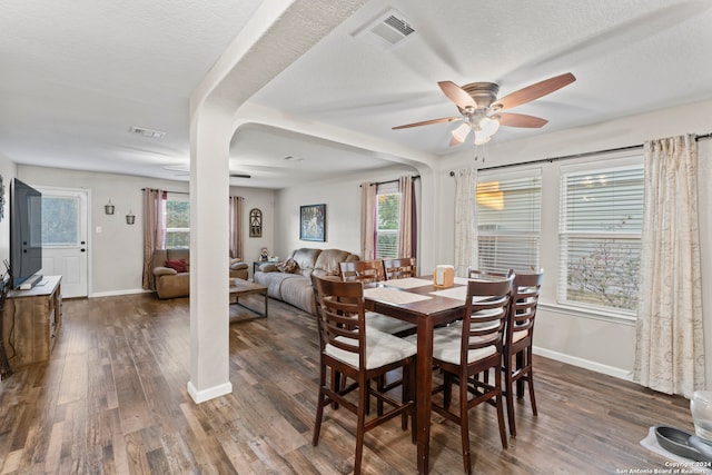 dining space with a textured ceiling, dark hardwood / wood-style floors, and ceiling fan